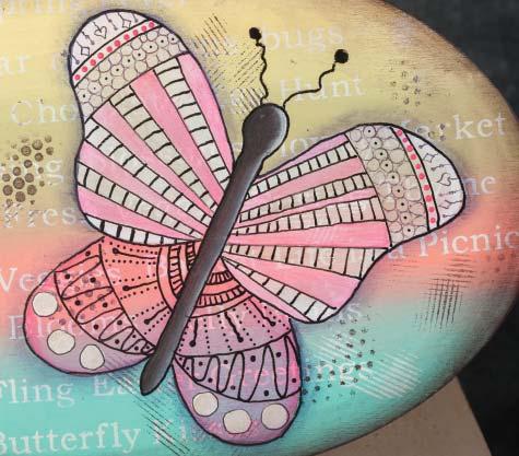 Add Champagne Gold metallic on a couple of the lined stripes and the area with doodled circles. Paint smaller wings with Glazing Medium and Dragon Fruit.