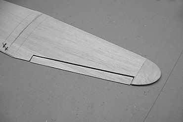 Glue the panels together. We suggest 15-minute epoxy for this joint. Cut the ailerons free from the completed wing. Wrap the center section of the assembled wing with a strip of 2.
