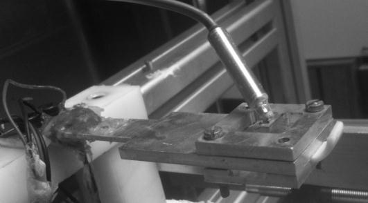 the cantilever beam supports the thermocouple, it also has a pilot hole for the wire waveguide to enter.