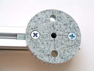 The screw holes in the discs are counter-sunk so that the heads of the screws are just below the surface when