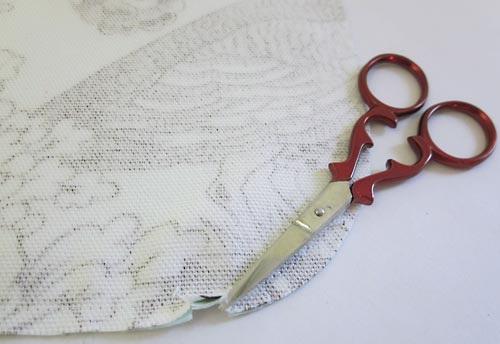 These curved ends will be the ends that knot together at your shoulder, so you want to make sure you are cutting the top ends. 6. Trim back the End template along the dashed seam line.