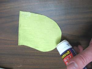 Fold the elastic into the center of the mask and tape it flat.
