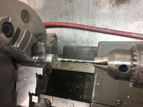 I drilled through using my 1/8" drill bit. Feed in about a half inch and then retract. Remove all swarf caught in the flutes of the drill bit.