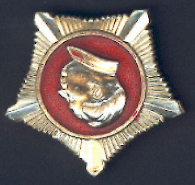 5 cm Description: Gold pentagonal pin with raised gold left profile of Mao at center, surrounded by circle of red.