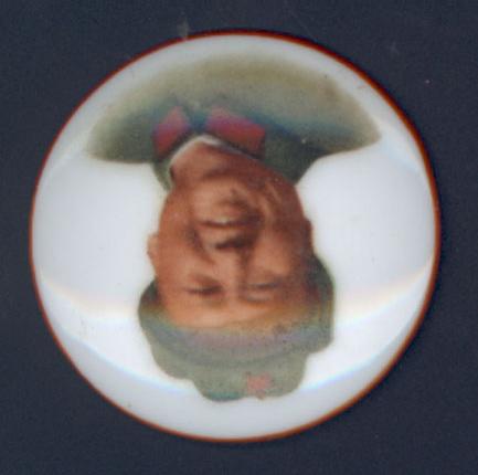 porcelain pin with color profile of older Mao at center, surrounded by white background