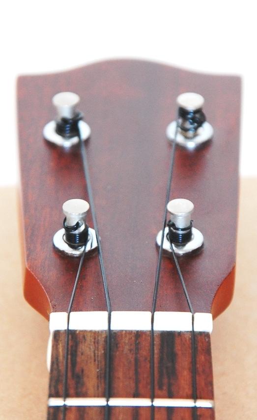 If the string gets a hold you can rotate each tuner at the backside of the headstock forward or backward (second photo on the right).