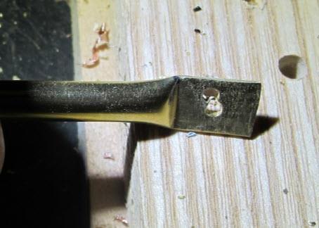 See photo below Using a 5/64-inch drill bit drill a hole 3/16-inch off the tube edge.