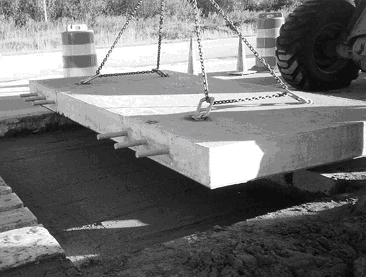 transfer dowel bars installed in each wheel path. The bars are cast 300 mm (1 ft) apart into the slabs on both sides of the transverse joint. Consequently, the total number of dowels per slab is 12.