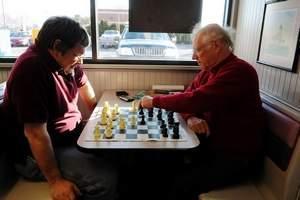 David Boucher watches as opponent Tom Broyles makes his move during a chess game at the St. Clair Burger King. They are part of a club that meets each Saturday morning at the restaurant.