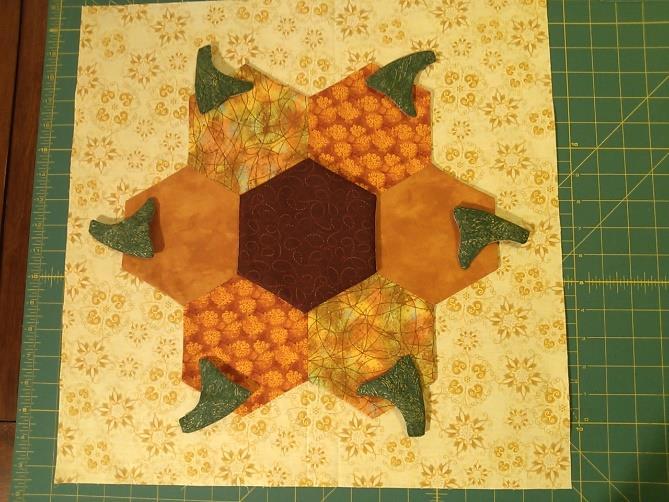 Assemble the Pumpkin Ring and Background Center the pumpkin ring on top of the background square, using the creases in the