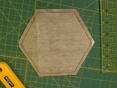 Cut out the template on the drawn line. Trace the hexagon template onto the smooth side of the fusible web square.