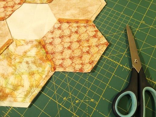 Center the hexagon circle on the bumpy side of the fusible web (or on the muslin square,