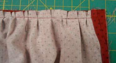 Stitch, using a 1/2" seam, and backstitching at both ends. Remove the pins and the gathering string, and gently press the waistband up and away from the apron front.