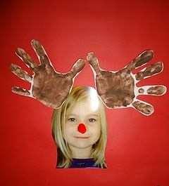 The children cut out and glue on their handprints for antlers and glue a circle