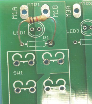 This will secure them so you may flip the board upside down. The large resistors should match up to the three larger footprints along the top of the board.