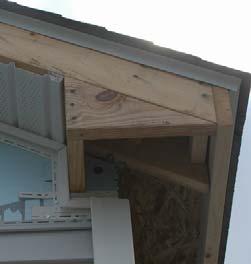 The left photo shows J inside the corner post, mitered at the inside corner of the notch in the siding, and continuing up the side of the birdbox and then along the gable end under the soffit.