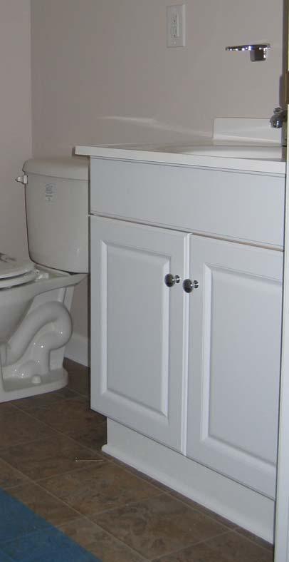 123. Install Bathroom Vanity Purchased vanities are pre-finished, come with hardware, and have two doors. Set the vanity in place. Place the sink/counter on top of the vanity.