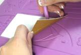 Simply place a sheet of card face down over the shape and rub the rounded edge of the embossing tool