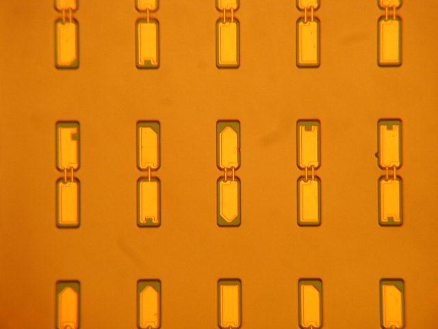 is shown in Figure 3. After fabrication the diodes are diced to form discrete flip-chip structures, typically of overall dimensions 120 x 35 x 15 (µm) 3 (L x W x H).