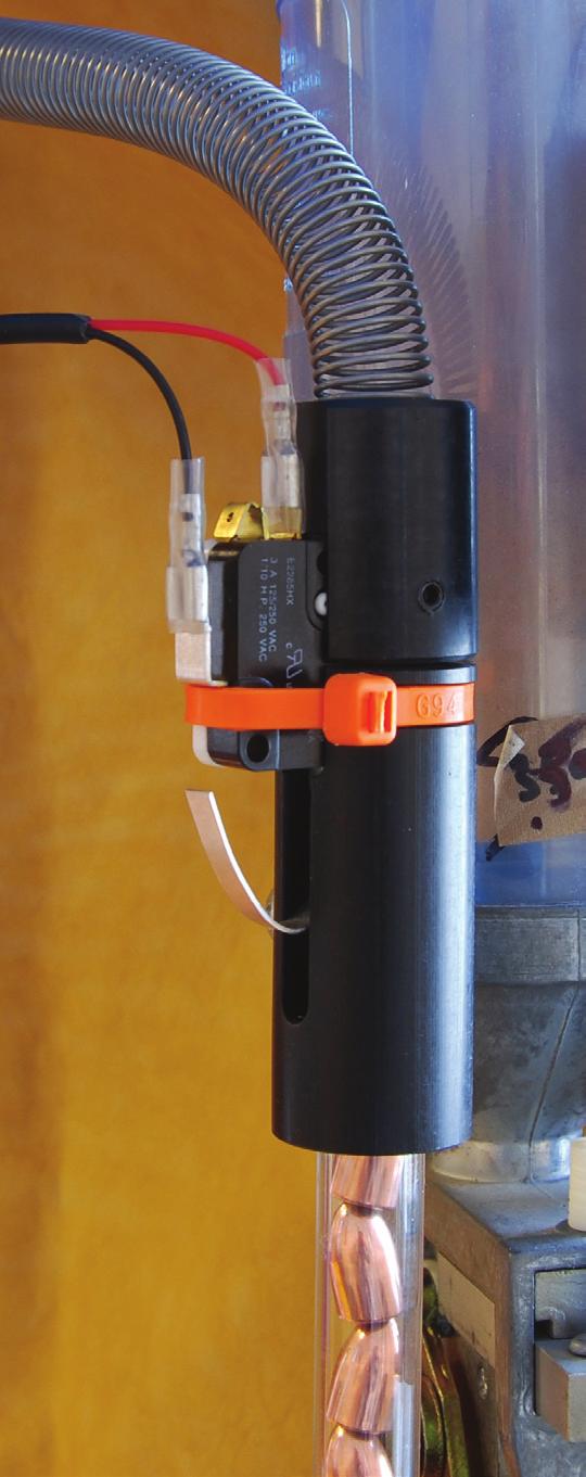 Note the position of the spring s adaptor cap as it attaches to the top of the dropper assembly. Its flat side fits snugly around the micro switch.