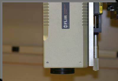 the camera is seeing through the transmissive material to the object being measured. One example of a transmissive material is germanium.