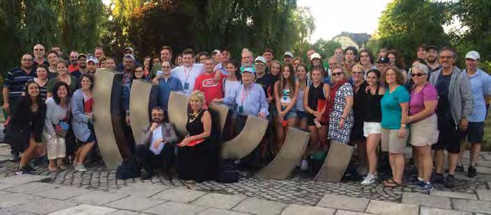 GROUP TRAVELS TO WITNESS POLAND S JEWISH PAST AND PRESENT The entire tour group at the menorah sculpture in Kielce, where Jews returning home after the Holocaust were murdered in 1946.