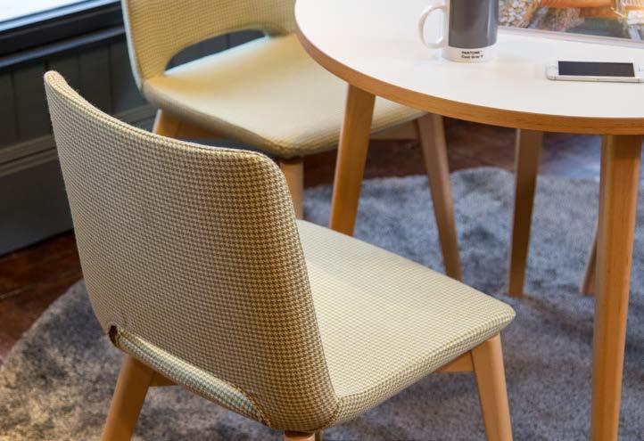 Use soft seating with natural wood legs and heavy, tactile fabrics to create