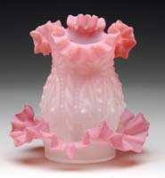 $690.00 CHIMNEY STYLE FAIRY LAMP. Ruf Fig. 248. Bulbous embossed opaque dome with fluted and deeply ruffled pink top rim. This pattern is embossed four times on the lamp.