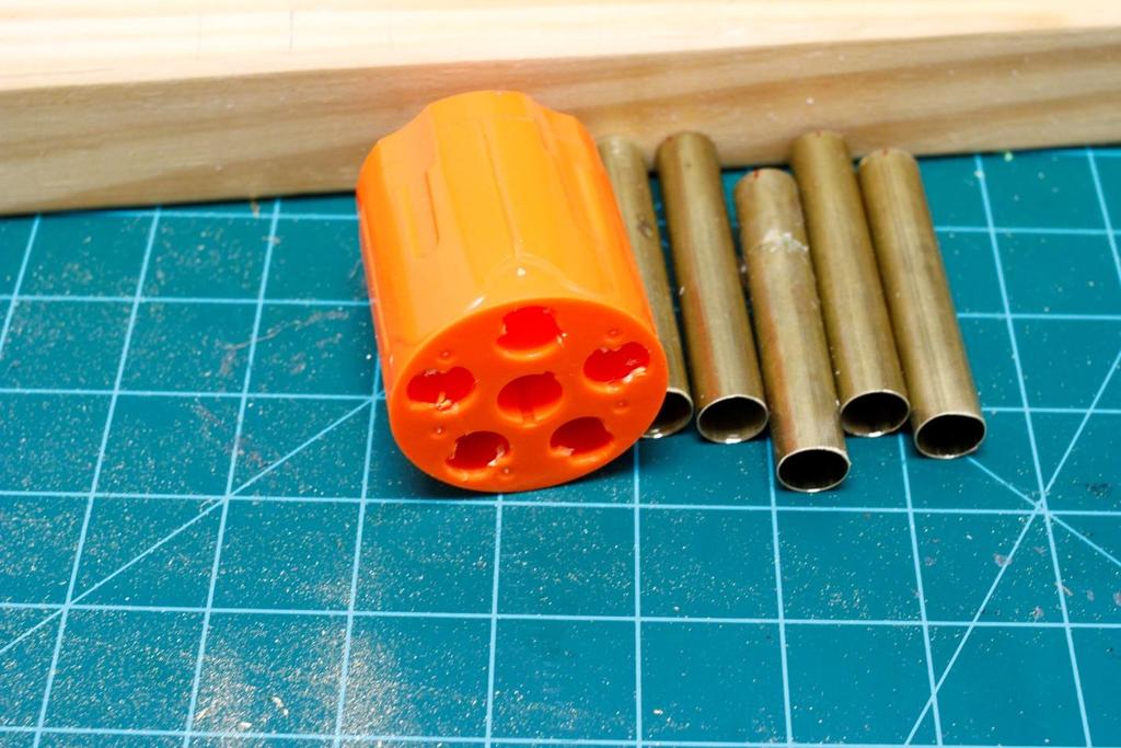 Step 4: Press your brass barrels into the cylinder one at a time using the scrap wood block.