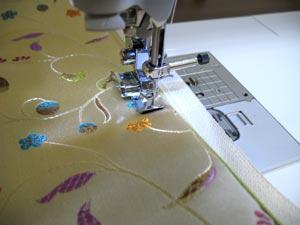 Using a zipper foot, sew a seam right along the top edge of the pocket, 1/8 inches from the zipper.