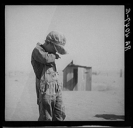 HARDEST HIT REGIONS Boy covers his mouth to avoid dust, 1935 Kansas, Oklahoma, Texas, New Mexico, and Colorado