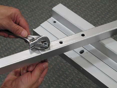 Align the assembled right leg with the corresponding elongated hole in the Horizontal Material Bar.