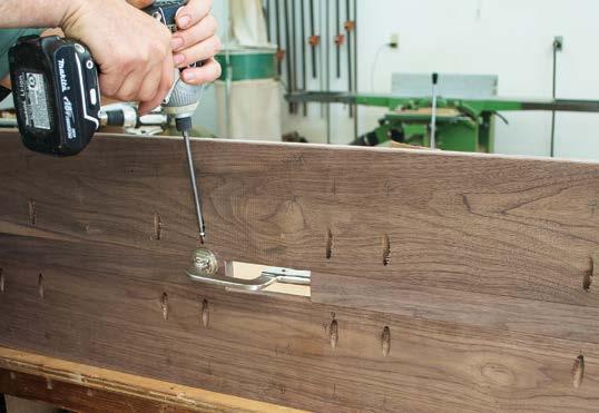 At the opposite end of the right-angle jig, hold tight with the face clamp and drive the first pair of screws.