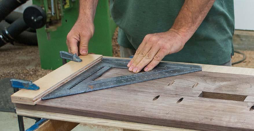 Square up the scrap spacer with the front edge of the bench. Mark the center of the benchtop in front of the spacer to help align the bench ends.