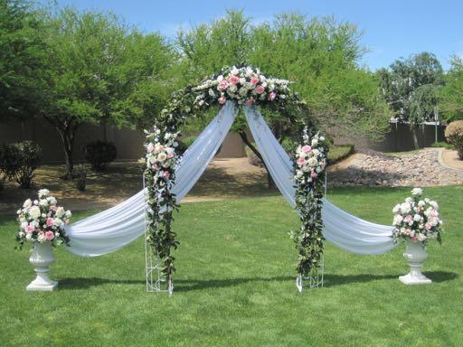 Gorgeous White Chiffon Drapes with Colour Coordinating Flower Arrangements, complete with 2 Matching Urns PRICE