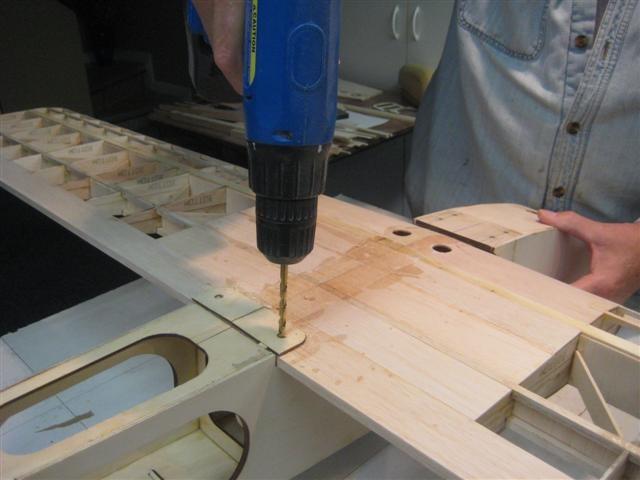 Drill two 13/64 diameter holes on center through the laser cut rear wing hold down plate,