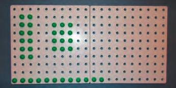 Repeat with the children swapping roles. Solve problems using materials to show arrays. Give each pair a peg board and write a 3x multiplication fact to show using an array, e.g. 3 x 5.