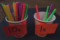 g. 100s are represented using shells, 10s are represented using buttons and 1s are represented using straws.