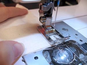 Sew a 1/4 inch seam along three sides of the square,