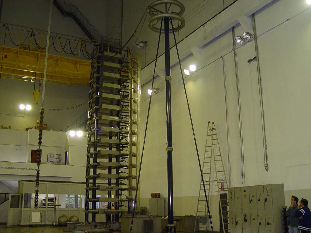 Fig. 12 Laboratory setup for the switching transients tests, showing the capacitive divider (at left), impulse generator (center) and the reference divider (at right).