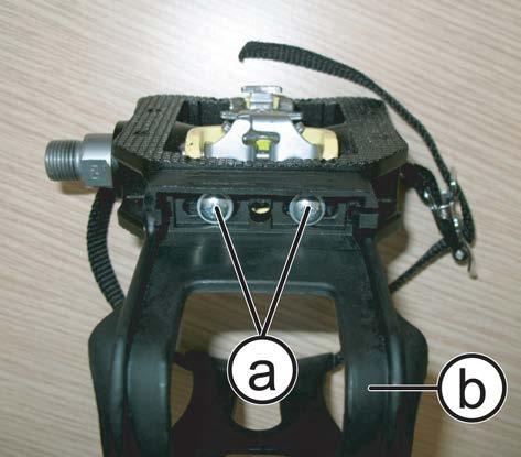 6.5.3 DISASSEMBLING THE PEDAL CAGE 1. Back off the 2 screws (a) using a medium Phillips screwdriver. 2. Remove the pedal cage (b). Figure 6.