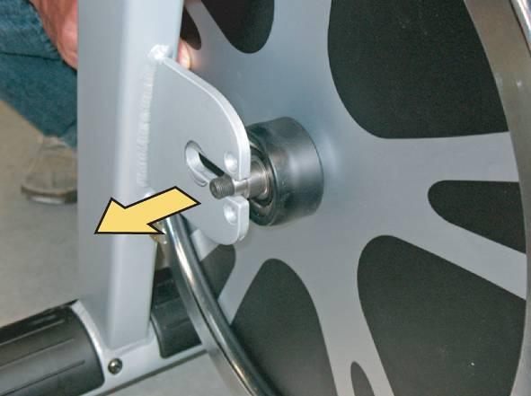 Insert a wrench into the flywheel shaft hole and lift it up to put it on the it s