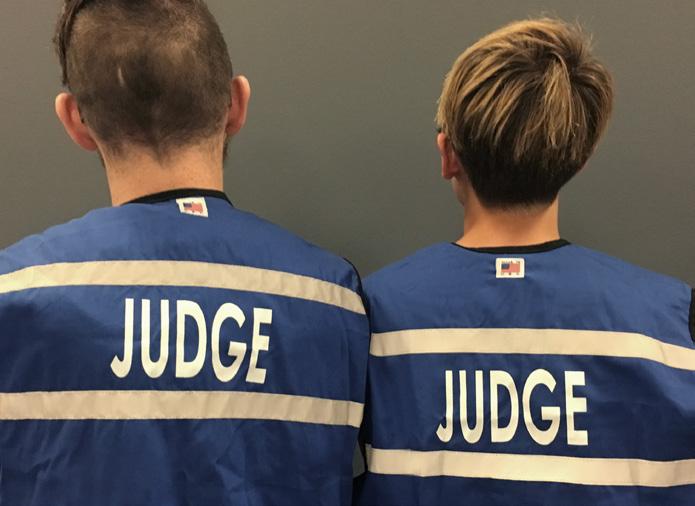 Staff wearing blue vests are judging staff.