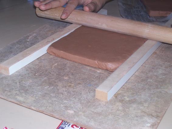 ROLLING SLAB SLAB CONSTRUCTION: A. Put a flat lump of clay on canvas between tow ¼ thick sticks or pencils. Using a dowel rod or rolling pin, roll clay out into a flat slab. B.