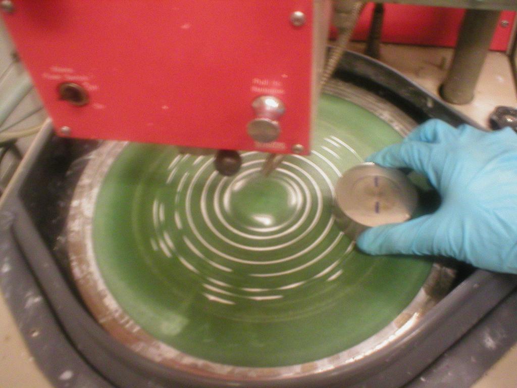 Image 5: Grinding with alumina powder 9. Polish sample at 300 rpm for two or three minutes using no water, again making circular motions with your hands. Hold on tight!