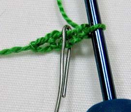 Slip Stitch (sl st) connect your chain into the bottom of first chain stitch. See how the paper clip marks the center?