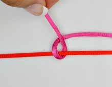 Make the second loop, placing the long end of the knotting cord