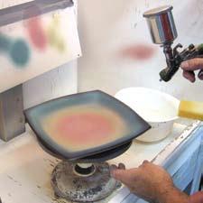 I spray very wet, as if I m pouring on a small stream of the glaze or engobe on the piece.