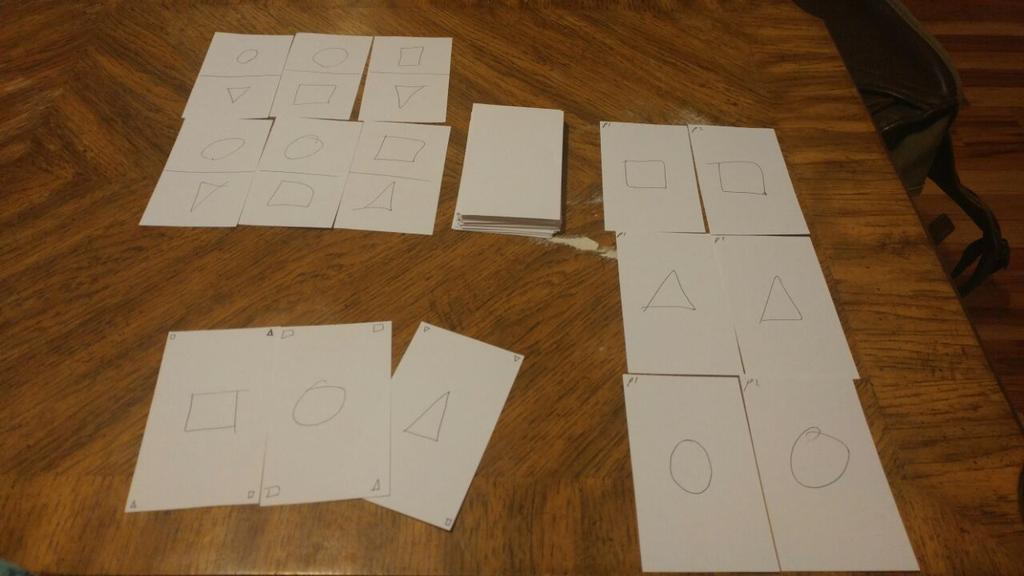 All game pieces DESIGN PROCESS STATEMENT When we first began addressing this assignment, we had two ideas that we were running with--the idea of matching shapes on card edges to place cards, and the