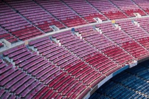 [Photo3/Stadium] Outdoor sport for surfaces: Faded plastic seats of a sports stadium demonstrate the effects of weathering.